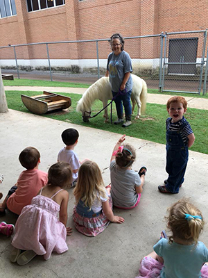 preschool students and teacher with miniature pony